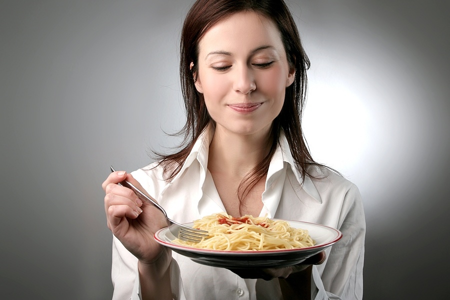 a young woman with a plate of pasta